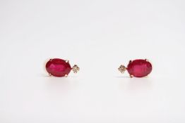 Pair of oval-cut treated ruby and diamond studs, boxed. Rubies 2.00ct. Diamonds 0.06ct