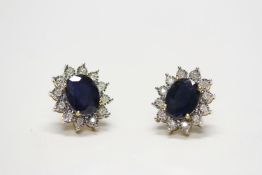 Pair of 9ct yellow gold oval-cut sapphire and round-cut diamond cluster ear studs, boxed.