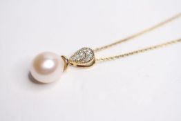 9ct yellow gold necklace with a suspended pear drop cultured pearl and r/c diamond-set bale.