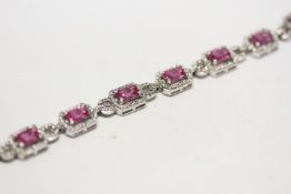 18ct white gold pink sapphire and diamond cluster line bracelet, boxed. Pink sapphires 7.49ct.