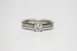 14ct white gold diamond solitaire ring with diamond shoulders and diamonds set to each side. Central