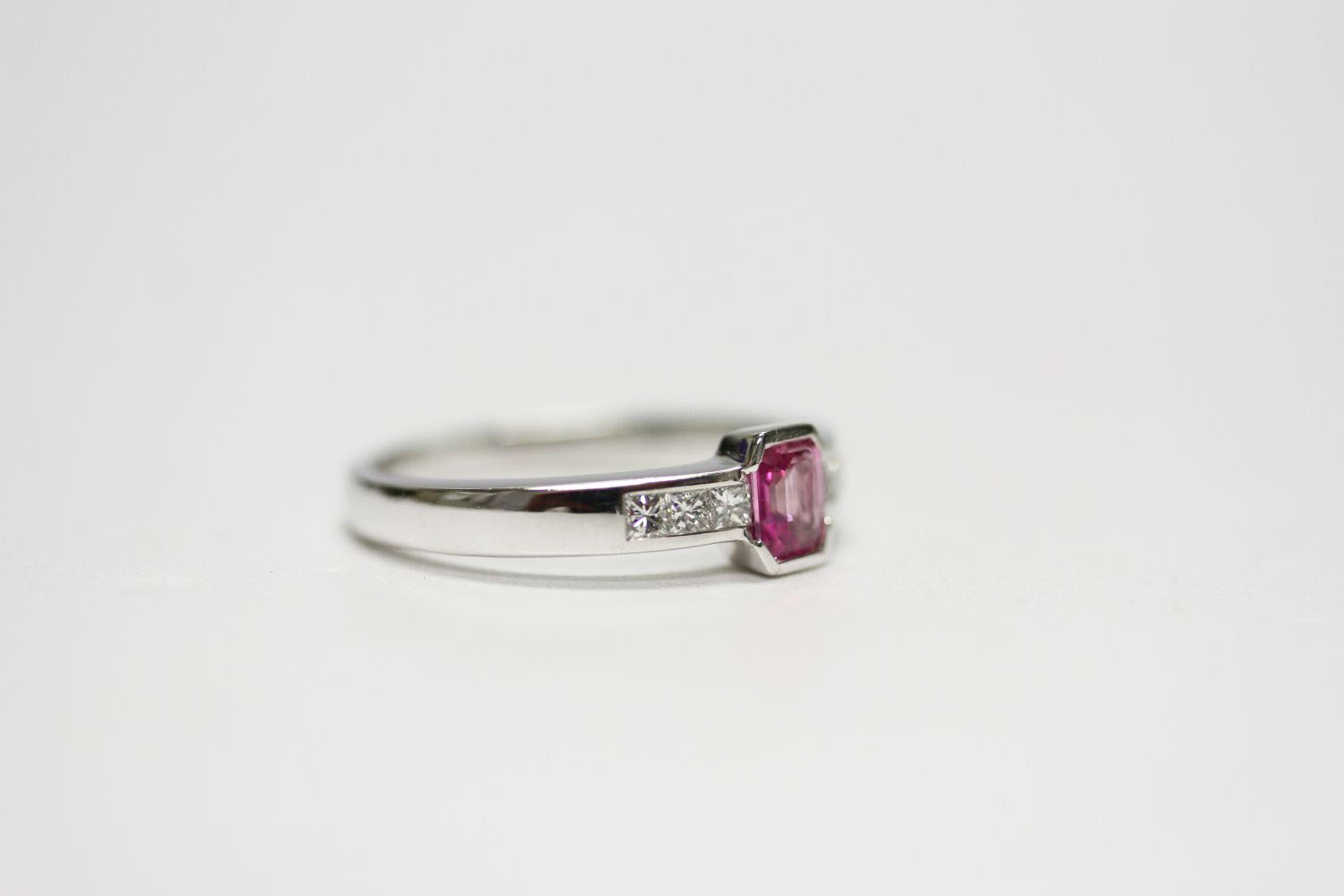 18ct white gold semi-rubover-set pink sapphire and channel-set diamond ring. Emerald-cut pink - Image 2 of 3