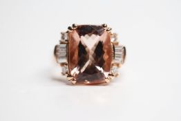 18ct rose gold ring set with a large morganite flanked by round brilliant cut diamonds and