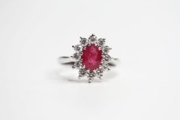 18ct white gold oval ruby and diamond cluster ring. Ruby 1.20ct. Diamonds 0.77ct