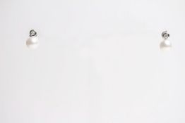 Pair of 18ct white gold earrings set with a round white cultured pearl and a diamond in a rub over