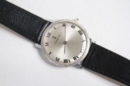 VINTAGE CORUM WRIST WATCH. Circular sunburst silver dial with arabic numeral hour markers, 30mm