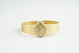 LADIES OMEGA 18CT GOLD COCKTAIL WATCH, oval gold dial with stick hour markers and hands, 22mm 18ct