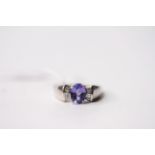 Tanzanite & Diamond Ring, set with an oval cut tanzanite, claw set, baguette cut diamonds, 18ct