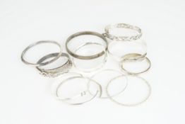 GROUP OF 12 SILVER BANGLES, sterling silver and silver bangles, cuffs, some adjustable, gross weight