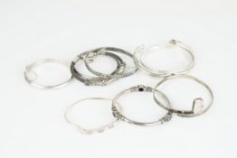 GROUP OF 9 SILVER BANGLES, sterling silver and silver bangles, cuffs, some adjustable, gem-set,