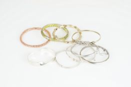 GROUP OF 9 SILVER BANGLES, sterling silver and silver bangles, cuffs, some adjustable, some gem-set,