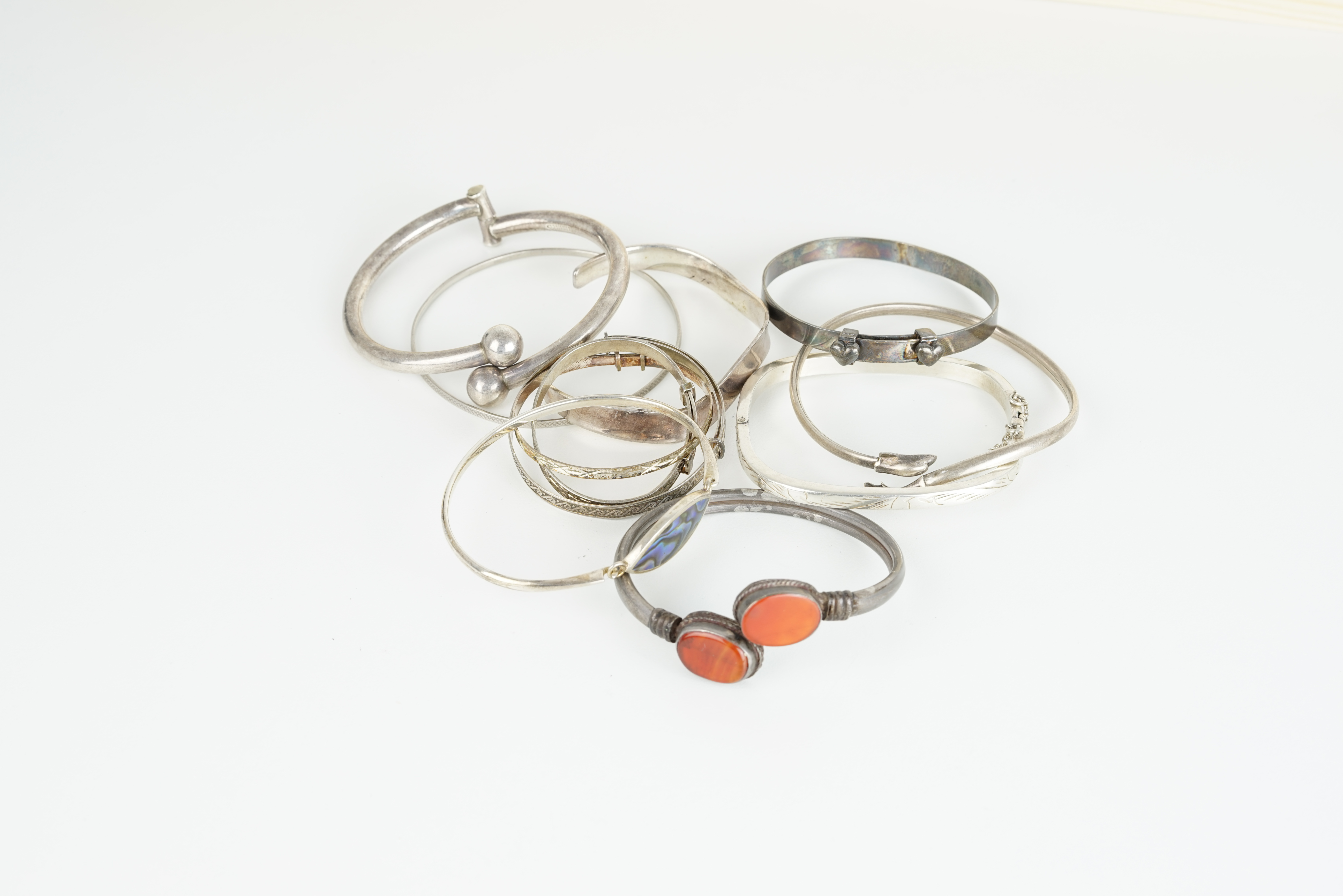 GROUP OF 11 SILVER BANGLES, sterling silver and silver bangles, cuffs, some adjustable, gem-set,
