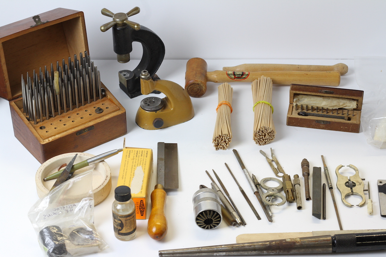 * TO BE SOLD WITHOUT RESERVE* A box of watch makers tools including vintage tools, clamps, files,