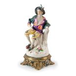PORCELAIN FIGURE OF SEATED MAN
