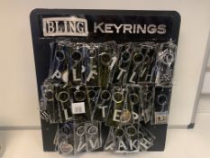 150 X NEW PACKAGED BLING KEY RINGS IN ASSORTED DESIGNS/INITIALS. RRP £5 EACH. COMES ON A DISPLAY