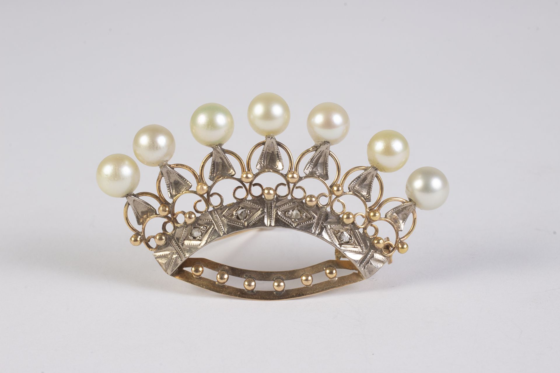Broche en forma de corona en oro y platino con diamantes talla rosa y perlas cultivadas.