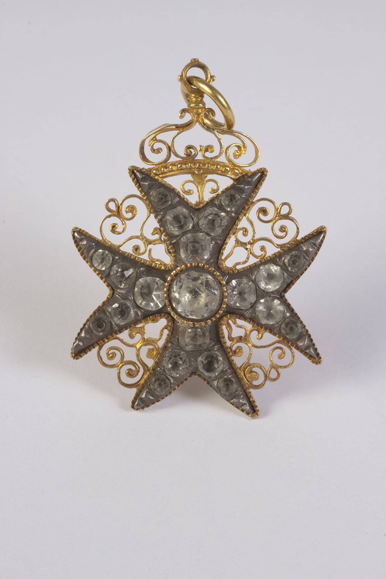 Colgante en forma de cruz de Malta con corona en oro, plata y cristal de strass.