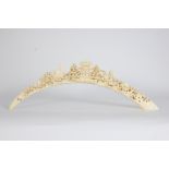 Ivory tusk carved with architectural motifs and figures.