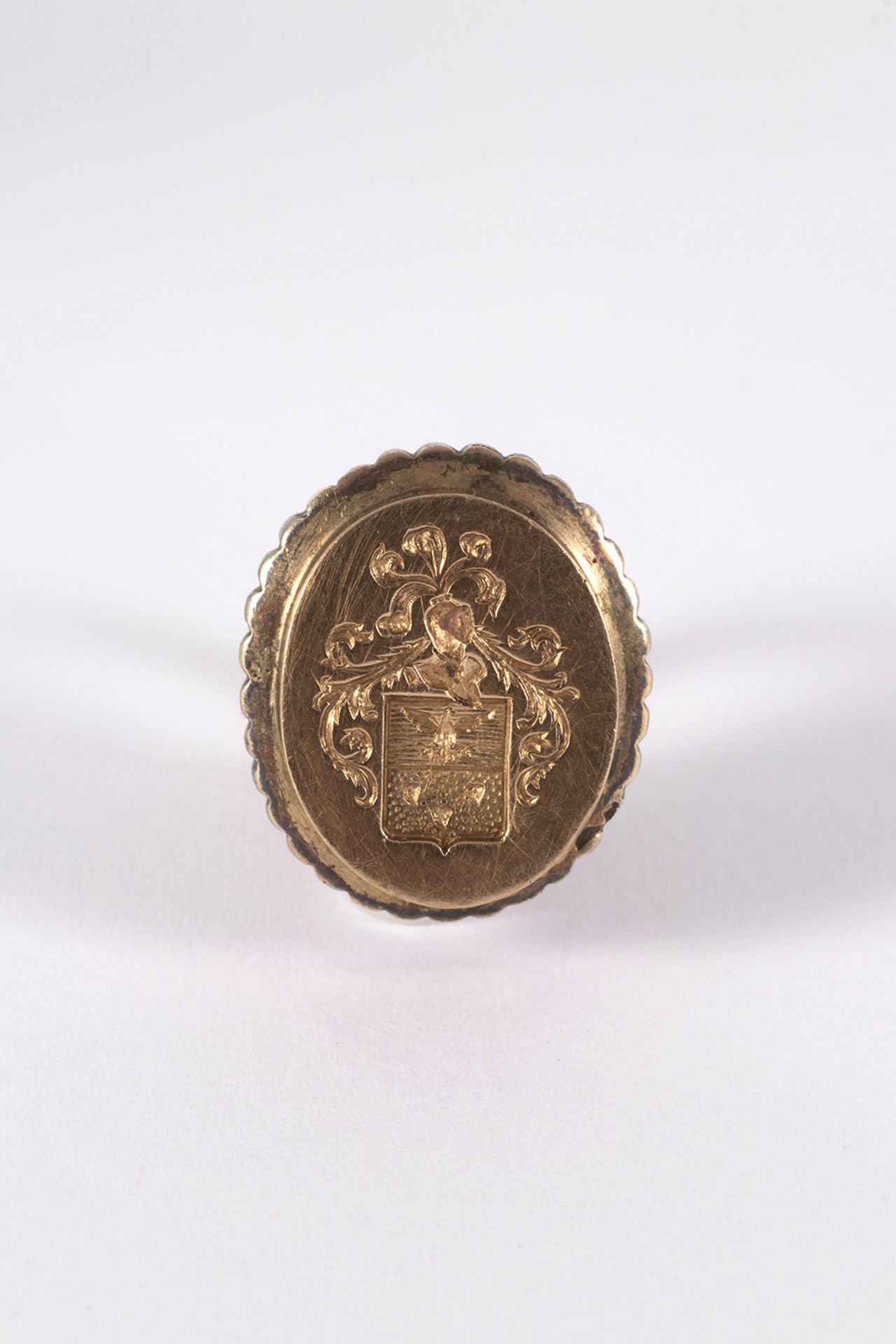 Seal pendant in gold and silver with heraldic shield.