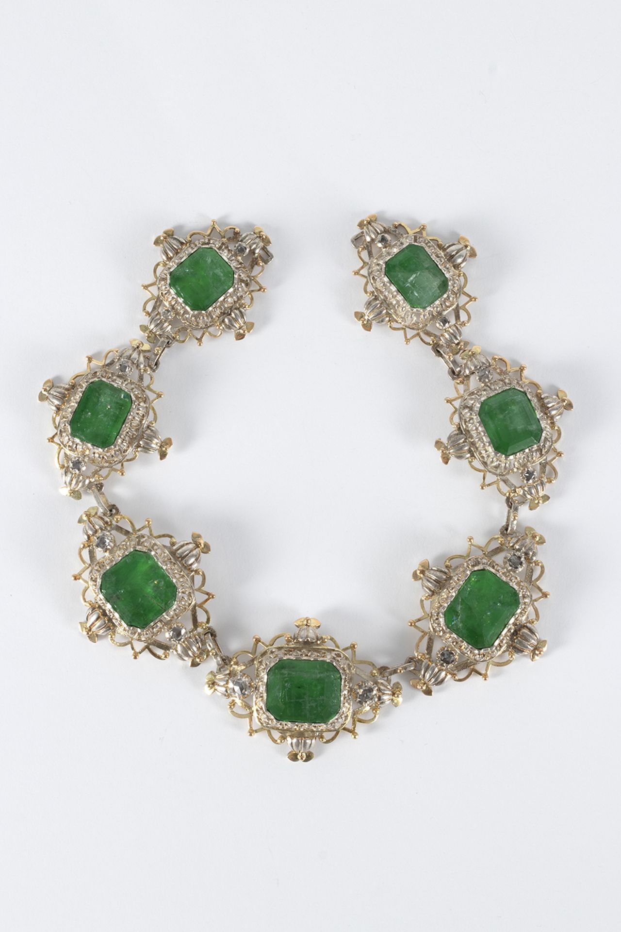 Necklace front, Elizabethan style in silver and gold details with emerald centers, octagonal cut.