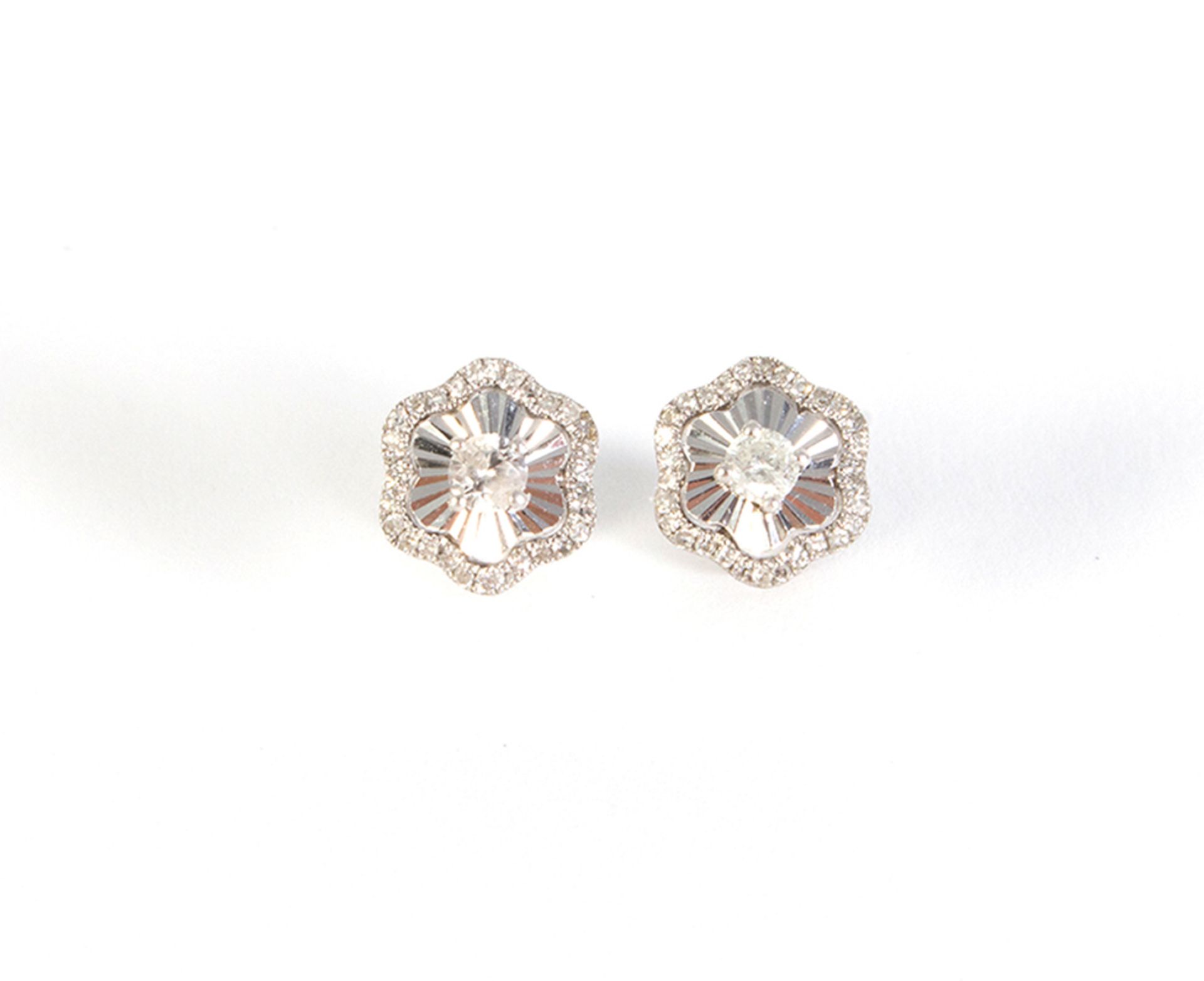 White flower earrings and brilliant cut diamonds.