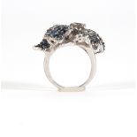 Silver ring with round cut blue sapphire leaves.