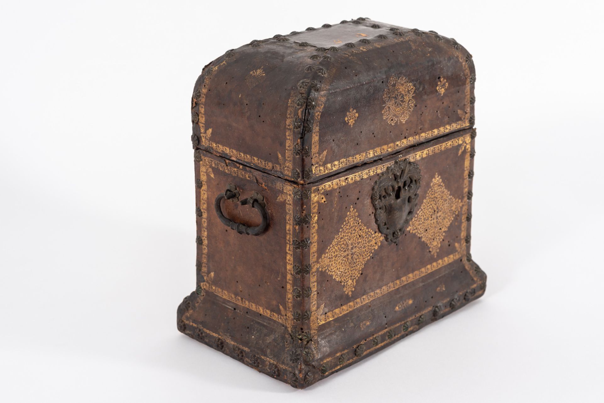 Wooden travel chest covered with gilt leather and studded with iron handles and keyholes, 18th centu