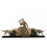 Lady with bird and dog. Art Deco sculpture in patinated corrugated iron on a marble base.