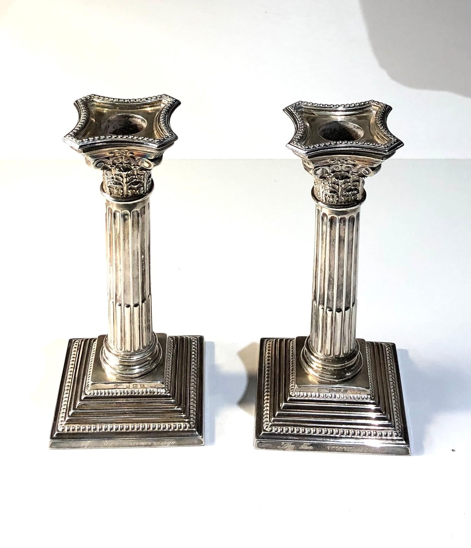 Pair of silver corinthian column candlesticks measures approx height 19cm weight 600g engraved