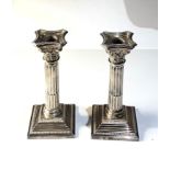 Pair of silver corinthian column candlesticks measures approx height 19cm weight 600g engraved