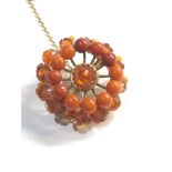 carved amber bead brooch