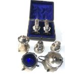 Selection of silver items includes hallmarked silver salts peppers etc and pair of peppers boxed