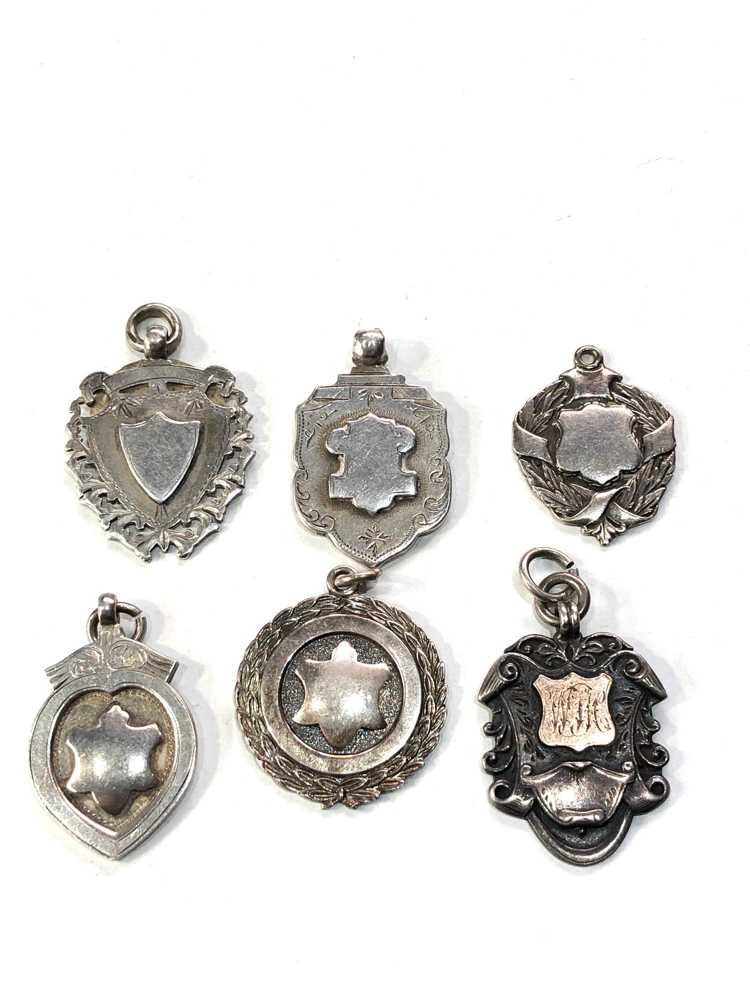 Selection of antique silver pocket watch chain fobs
