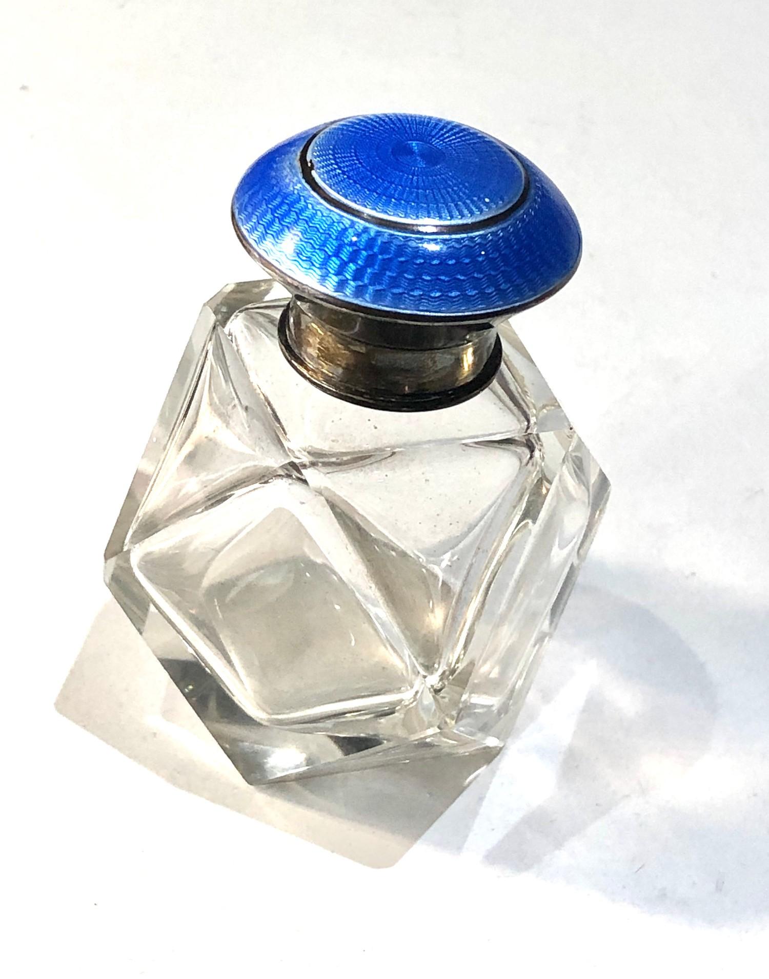 Antique silver and enamel top perfume bottle measures approx height 8cm complete with stopper