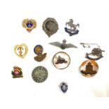 12 Military brooches including The Kings RAF, Royal Navy etc