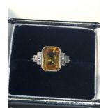 Fine platinum diamond and yellow sapphire ring set with large central yellow sapphire that