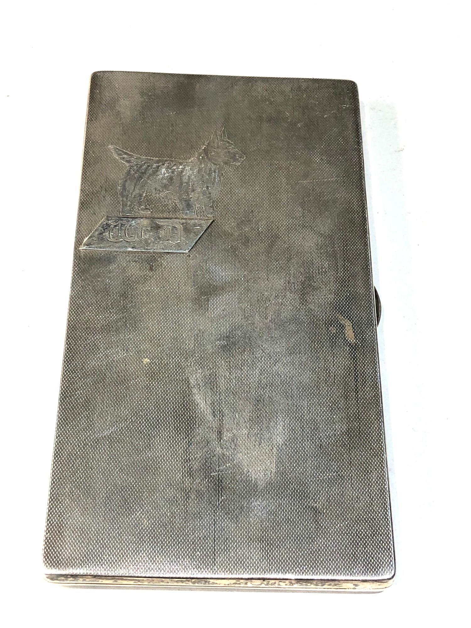 Large heavy engine turned cigarette case dog motif measures approx 15cm by 8cm weight 250g