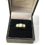 Fine 18ct gold opal and diamond ring central opal measures approx 6mm by 4mm with 4 old cut rose