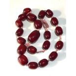 large cherry amber / bakelite type bead necklace largest bead measures approx 41mm by 28mm weight