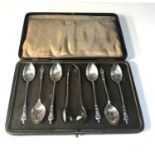 Set of 6 boxed silver apostle tea spoons and sugar tongues