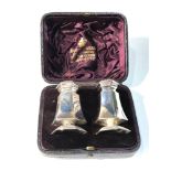 Boxed pair of antique silver peppers each measures approx 6cm tall comes in original fitted box worn