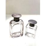 2 silver top and glass bottles both with silver screw tops largest measures approx 11.4cm tall