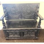 Oak heavily carved monks bench measures approx height 31" width 43" dept 20"