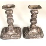 A pair of Edwardian silver rounded rectangular candlesticks, 18cm high London 1906, fitted as