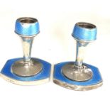 Pair of antique silver and enamel candlesticks measure approx height 9.3cm by 8cm wide filled