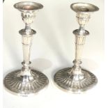 A pair of Edwardian silver half-fluted oval candlesticks Birmingham 1904 measure approx height 21.