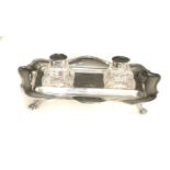 A George V silver shaped rectangular inkstand and pair of glass inkwells with dished pen rests,