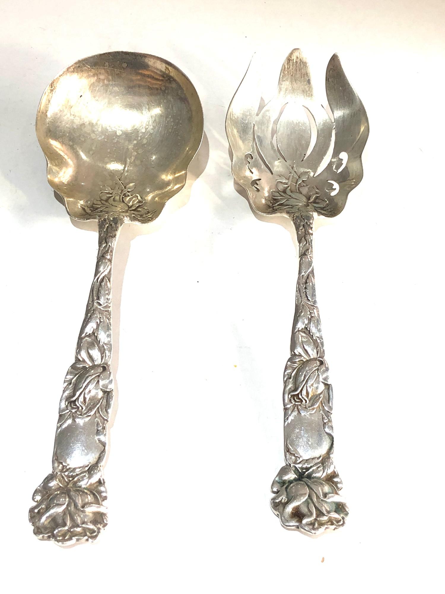 pair of ornate sterling silver servers with floral decoration measure approx 23cm long weight 200g