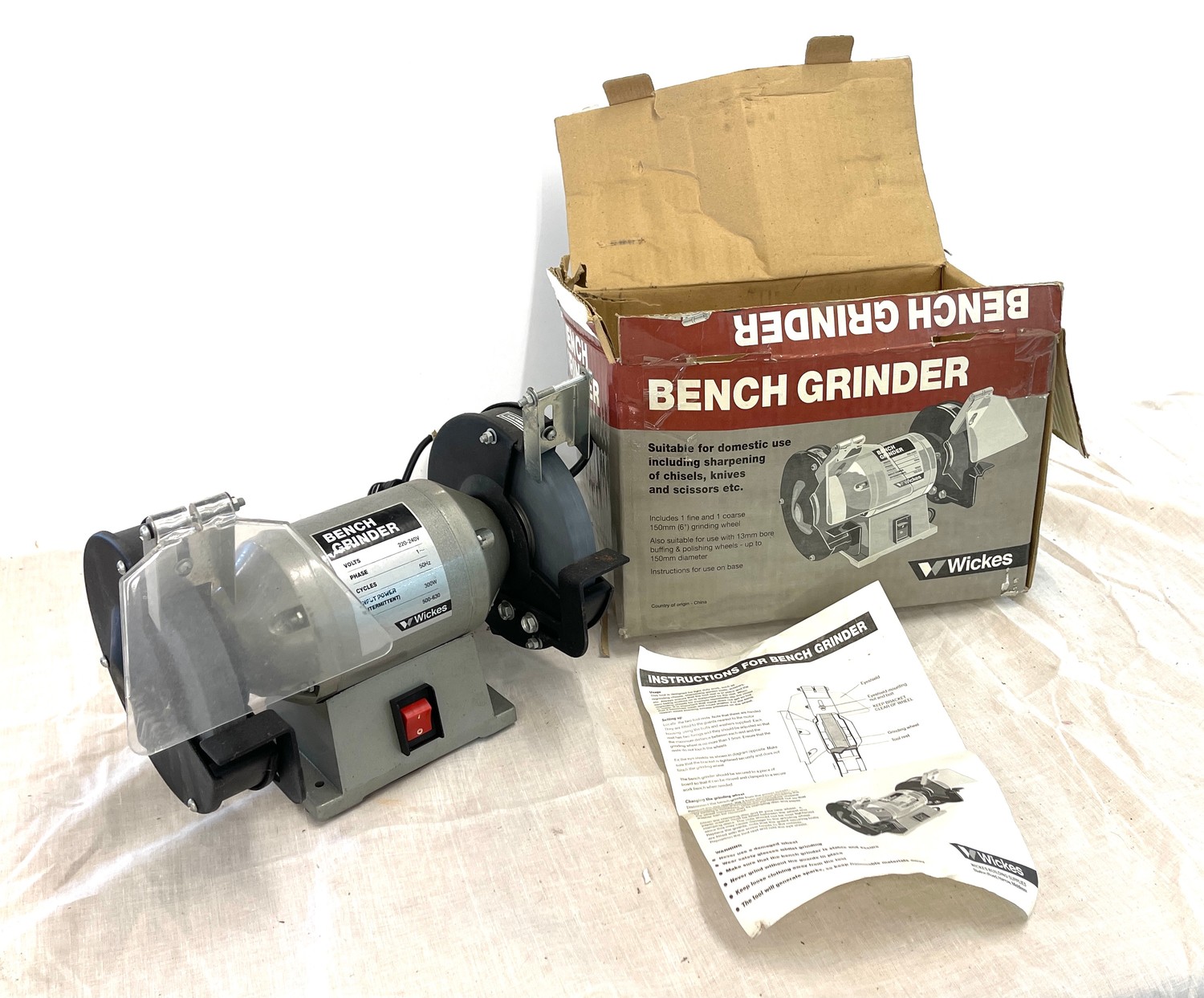 Boxed bench grinder, one plastic guard missing, working order