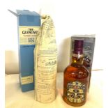 A bottle of Chivas regal whisky and a bottle of Glenlivet